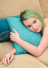 Paige Pierce with only her green socks and lying on the couch